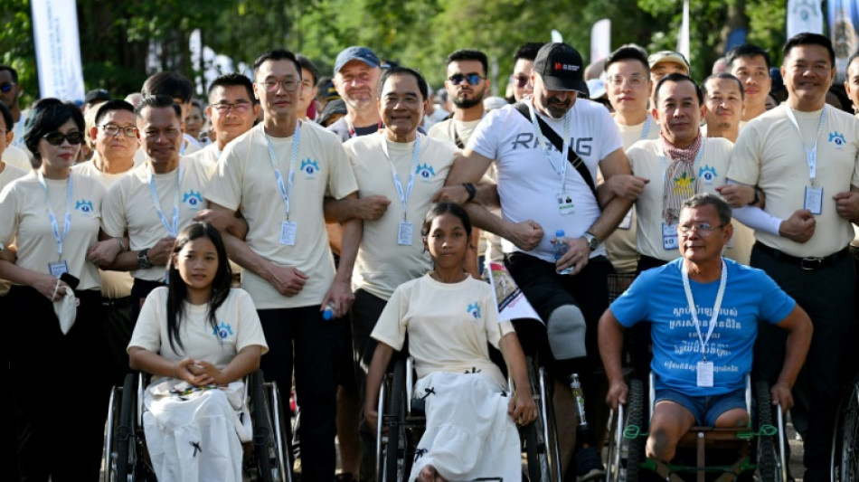 Survivors, sniffing dogs join anti-mine march at Cambodia's Angkor Wat