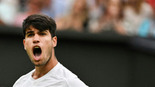 Alcaraz back from brink to beat Tiafoe in Wimbledon thriller